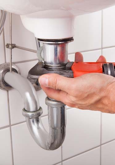 sink being fixed with a wrench