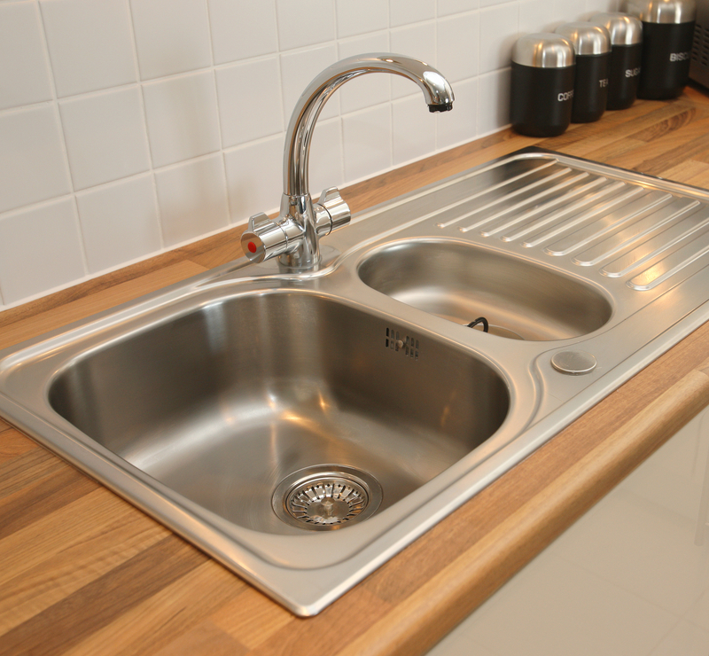 clean sink placed in a wooden countertop